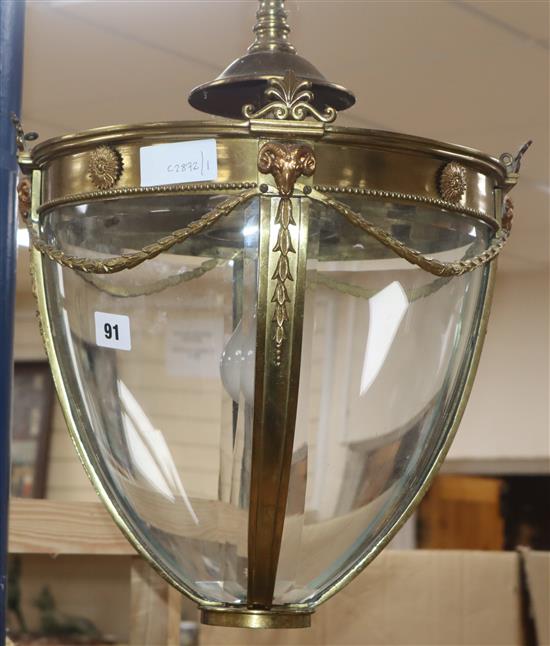 An Edwardian Adam design brass four glass hall lantern, with ram head mounts